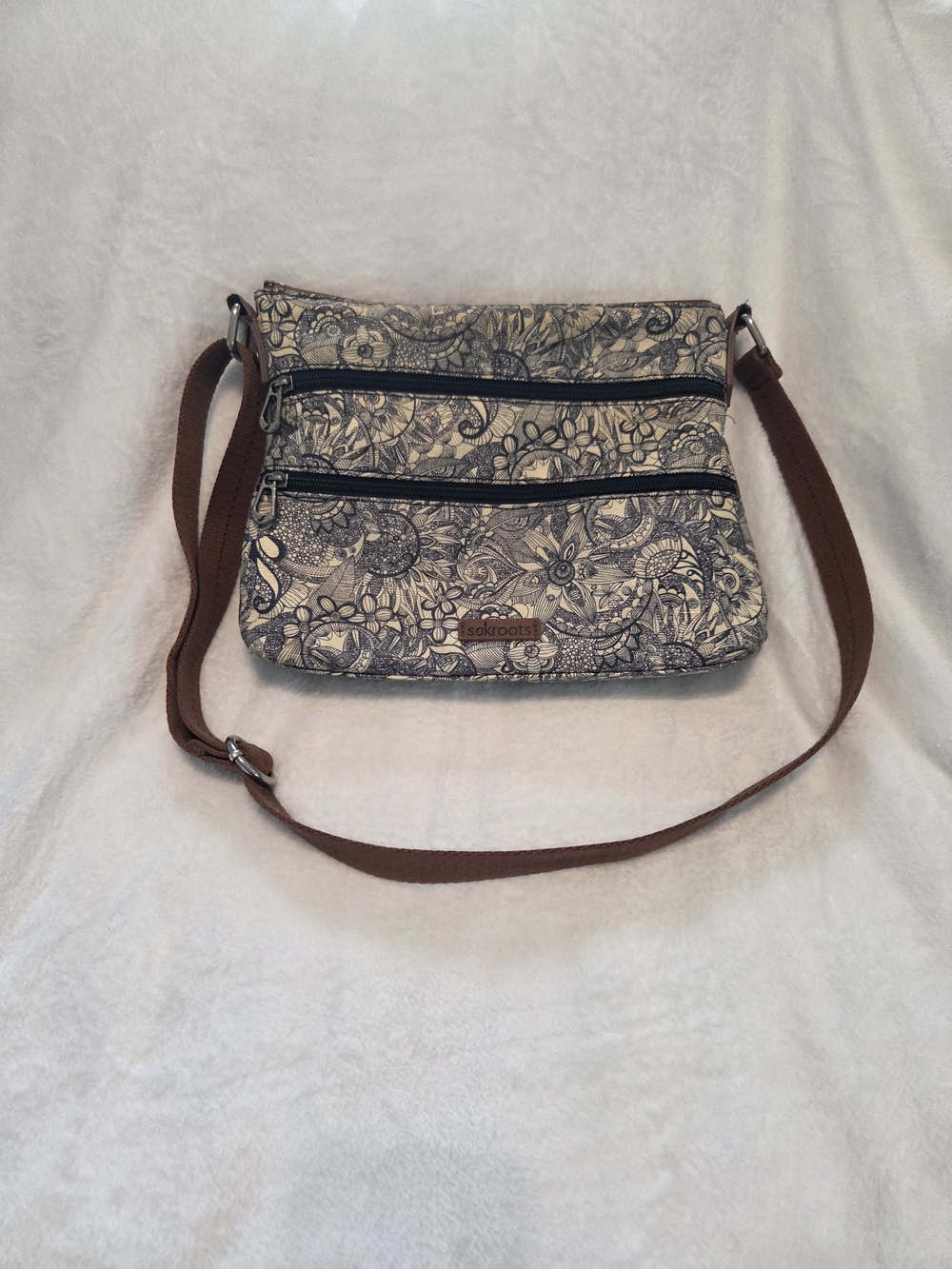 Sakroots Floral Crossbody Bag in Cream with Brown Strap